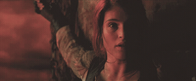 A Close Up Of A Woman 'S Face In A Dark Room With An Apple Logo In The Corner GIF