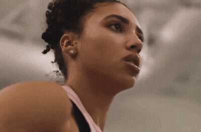 a close up of a woman 's face in a gym