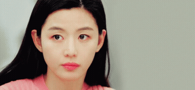 A Close Up Of A Woman 'S Face In A Pink Shirt GIF
