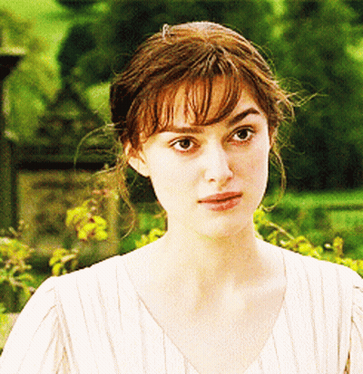 A Close Up Of A Woman 'S Face In A White Shirt GIF