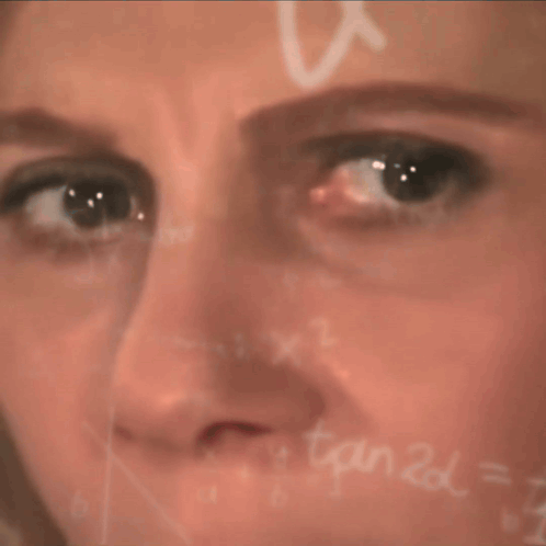 A Close Up Of A Woman 'S Face In Front Of A Chalkboard With X1 Written On It GIF