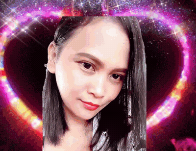 A Close Up Of A Woman 'S Face In Front Of A Heart GIF