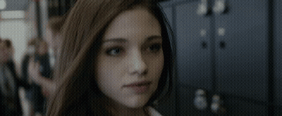 A Close Up Of A Woman 'S Face In Front Of A Row Of Lockers GIF