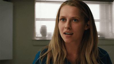 A Close Up Of A Woman 'S Face In Front Of A Window With Blinds GIF