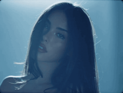 A Close Up Of A Woman 'S Face In The Dark GIF