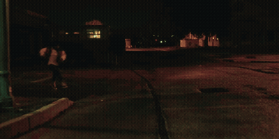 A Close Up Of A Woman 'S Face In The Dark GIF