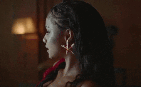 A Close Up Of A Woman 'S Face In The Dark GIF