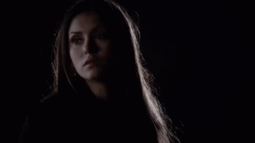 A Close Up Of A Woman 'S Face In The Dark With A Dark Background . GIF