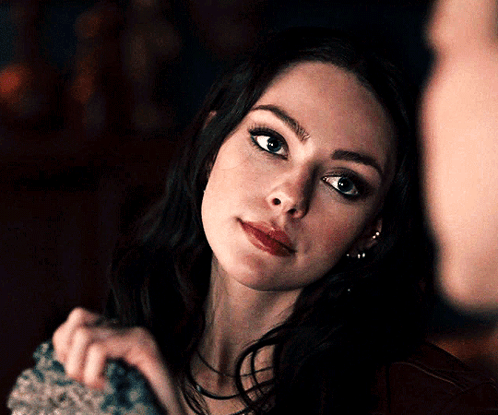 A Close Up Of A Woman 'S Face Looking At The Camera GIF