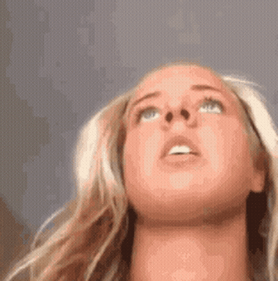 A Close Up Of A Woman 'S Face Looking Up . GIF