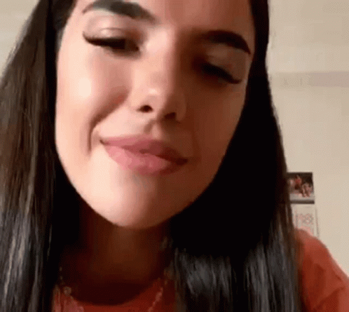 A Close Up Of A Woman 'S Face Making A Funny Face . GIF