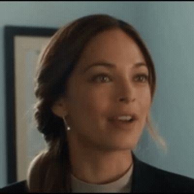 A Close Up Of A Woman 'S Face Making A Funny Face . GIF
