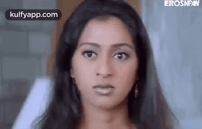 A Close Up Of A Woman 'S Face Making A Funny Face . GIF