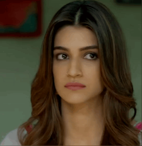 A Close Up Of A Woman 'S Face Making A Funny Face . GIF