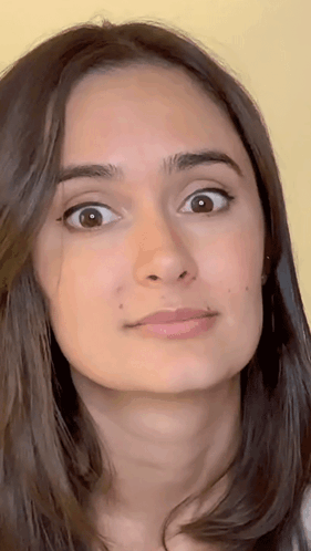 A Close Up Of A Woman 'S Face Making A Funny Face GIF
