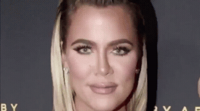 A Close Up Of A Woman 'S Face On A Red Carpet With A Black Background . GIF