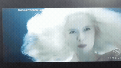 A Close Up Of A Woman 'S Face On A Screen With The Words Timeli On The Bottom GIF