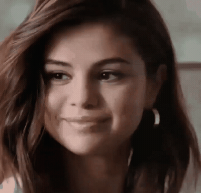 A Close Up Of A Woman 'S Face Smiling . GIF