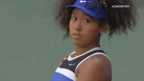 A Close Up Of A Woman 'S Face Wearing A Blue Hat . GIF