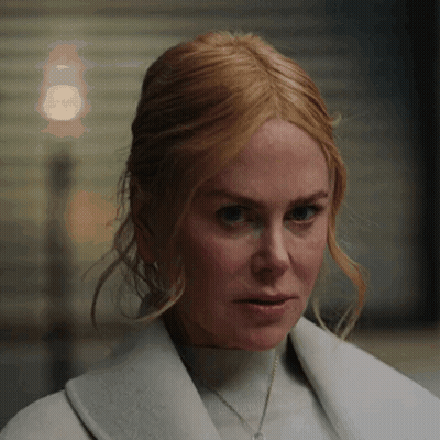 A Close Up Of A Woman 'S Face Wearing A White Coat . GIF