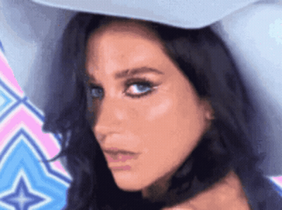 A Close Up Of A Woman 'S Face Wearing A White Hat GIF