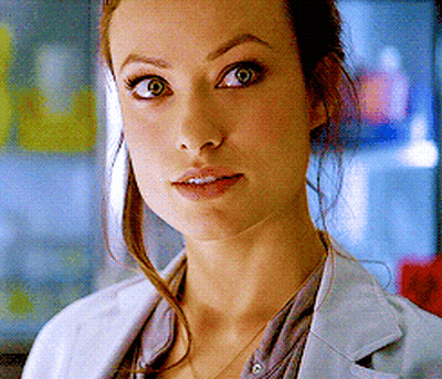 A Close Up Of A Woman 'S Face Wearing A White Jacket GIF