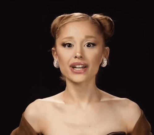 A Close Up Of A Woman 'S Face Wearing Earrings GIF