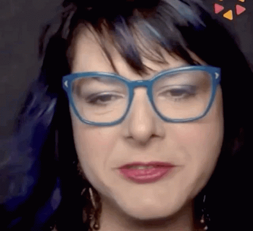 A Close Up Of A Woman 'S Face Wearing Glasses GIF