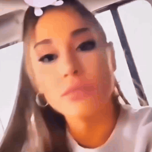 A Close Up Of A Woman 'S Face While Sitting In A Car Looking At The Camera . GIF