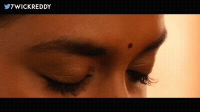 A Close Up Of A Woman 'S Face With 7Wickreddy In The Upper Right Corner GIF