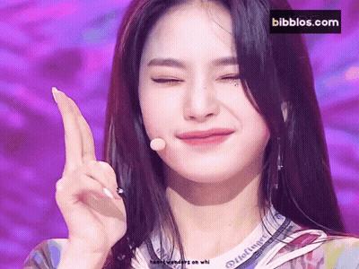 A Close Up Of A Woman 'S Face With A Bibbios.com Logo In The Background GIF