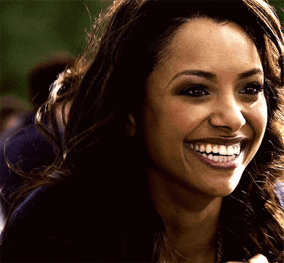 a close up of a woman 's face with a big smile on her face