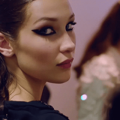A Close Up Of A Woman 'S Face With A Black Eye Shadow GIF