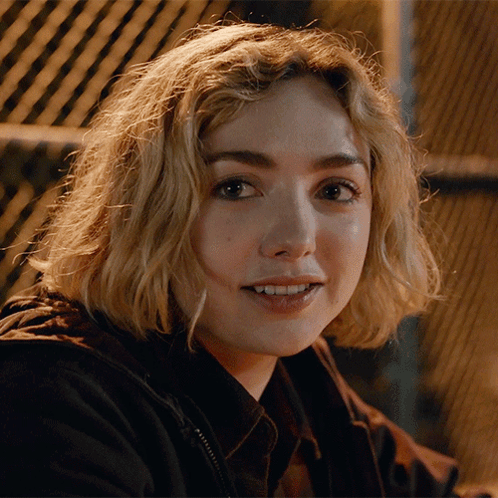 A Close Up Of A Woman 'S Face With A Black Jacket On GIF