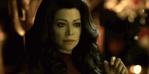 A Close Up Of A Woman 'S Face With A Black Jacket On . GIF