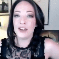 A Close Up Of A Woman 'S Face With A Black Lace Top On GIF