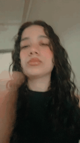 A Close Up Of A Woman 'S Face With A Black Shirt On GIF