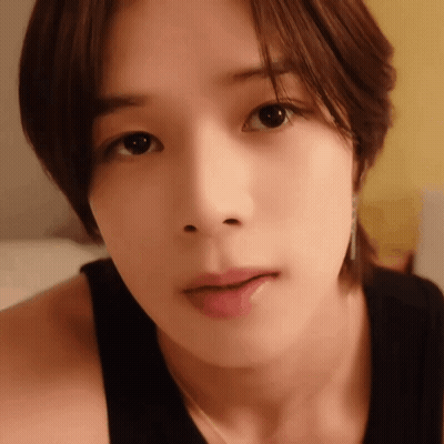 A Close Up Of A Woman 'S Face With A Black Shirt On GIF