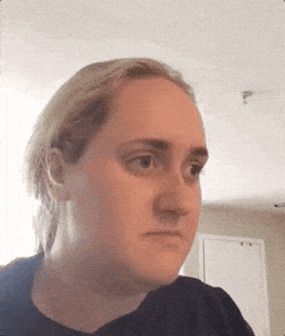 A Close Up Of A Woman 'S Face With A Black Shirt On GIF