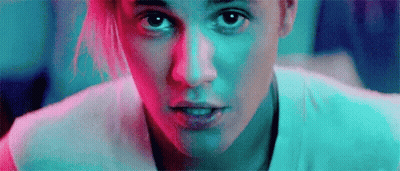A Close Up Of A Woman 'S Face With A Blue And Red Background . GIF