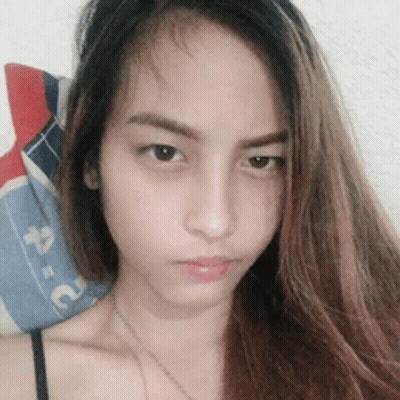 A Close Up Of A Woman 'S Face With A Blue And Red Pillow In The Background GIF