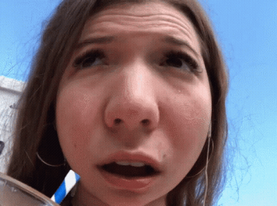 A Close Up Of A Woman 'S Face With A Blue And White Straw In Her Mouth GIF