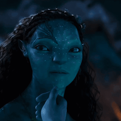 A Close Up Of A Woman 'S Face With A Blue Background GIF