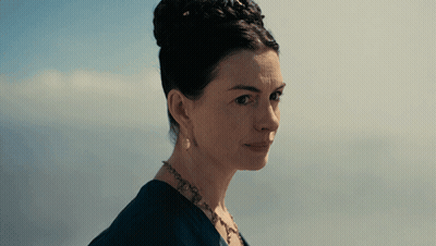 A Close Up Of A Woman 'S Face With A Blue Background GIF