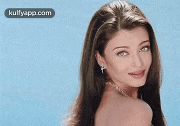 A Close Up Of A Woman 'S Face With A Blue Background . GIF