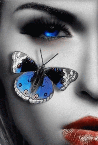 A Close Up Of A Woman 'S Face With A Blue Butterfly On Her Face GIF