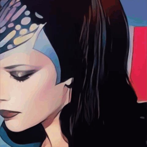 A Close Up Of A Woman 'S Face With A Blue Headpiece On GIF