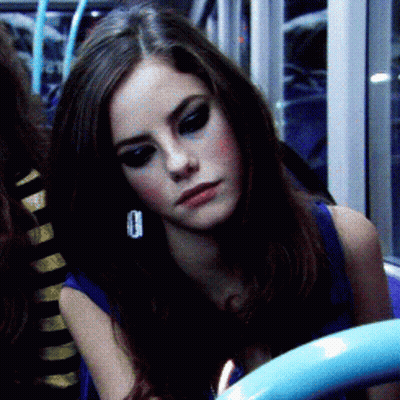 A Close Up Of A Woman 'S Face With A Blue Shirt On GIF