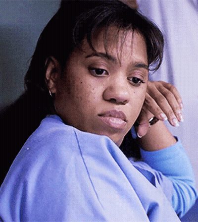 A Close Up Of A Woman 'S Face With A Blue Shirt On GIF