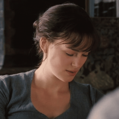 A Close Up Of A Woman 'S Face With A Blue Shirt On GIF